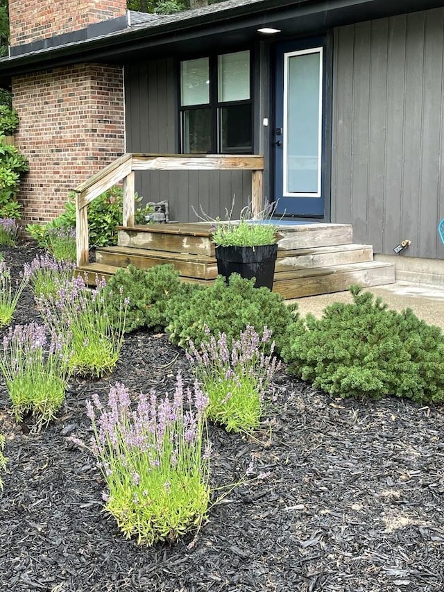 entrance to property featuring brick siding