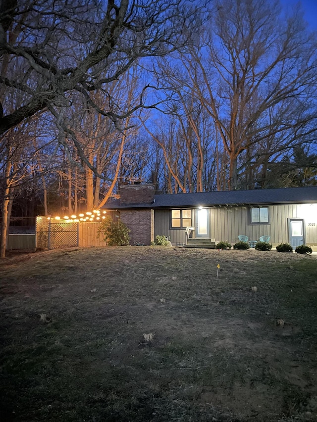 view of front of home with fence and a chimney