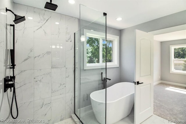 bathroom featuring a freestanding tub, recessed lighting, marble finish floor, and a marble finish shower