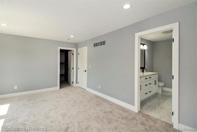 unfurnished bedroom with visible vents, recessed lighting, ensuite bathroom, and baseboards