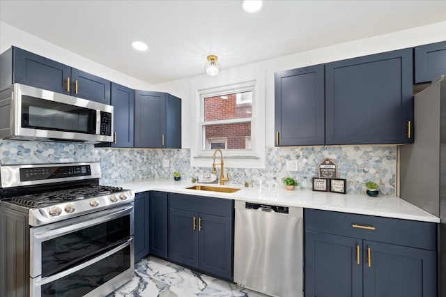 kitchen with a sink, marble finish floor, light countertops, appliances with stainless steel finishes, and decorative backsplash