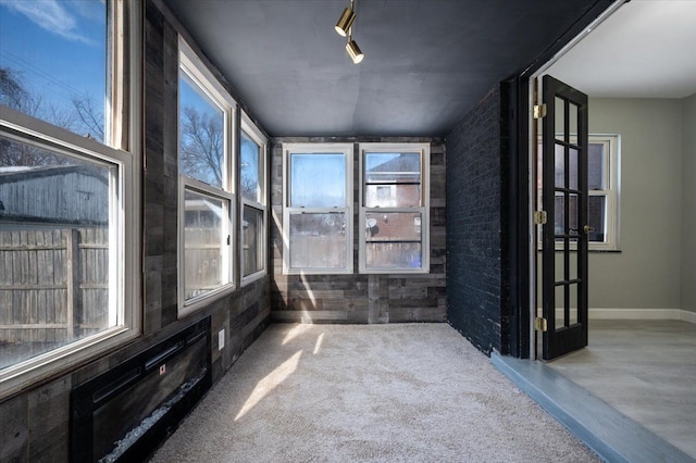 unfurnished sunroom with a healthy amount of sunlight