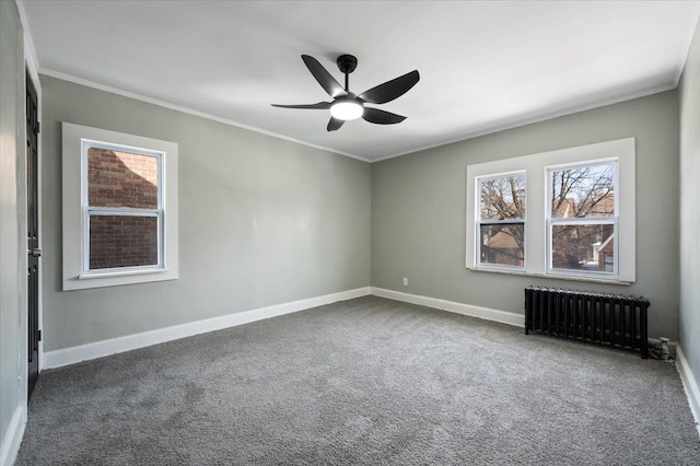 unfurnished room with radiator, baseboards, dark colored carpet, and ornamental molding