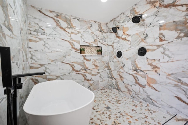 bathroom featuring tiled shower and a freestanding tub