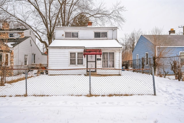 view of front of house featuring a chimney and fence