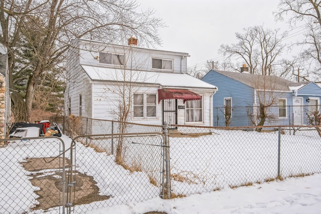 view of front of home featuring fence and a chimney