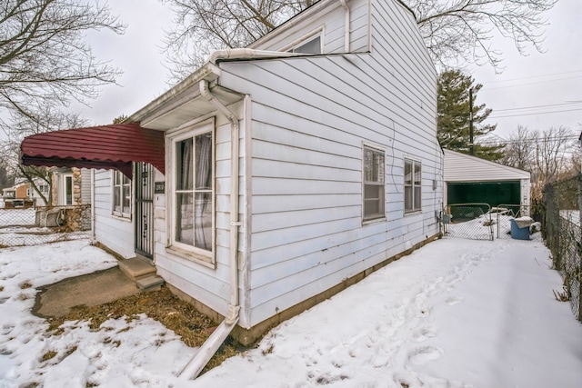 view of snowy exterior featuring fence