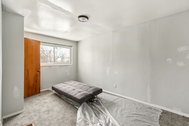 bedroom with light carpet and baseboards