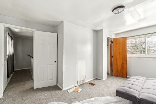 living room featuring light colored carpet, visible vents, and baseboards