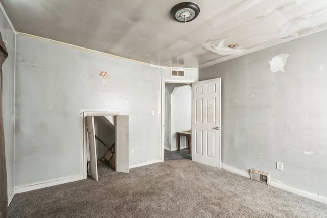 unfurnished bedroom with carpet floors, visible vents, and baseboards