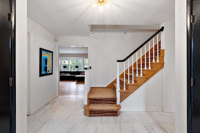 interior space with stairway and baseboards