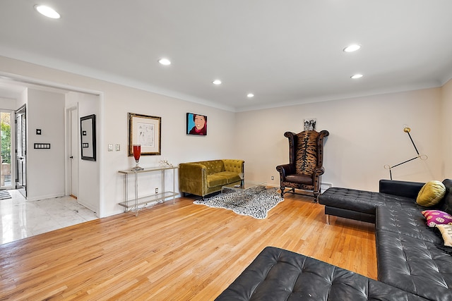 living room with light wood finished floors, baseboards, and recessed lighting