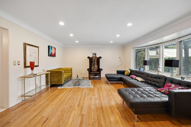 living area with ornamental molding, light wood finished floors, baseboards, and recessed lighting