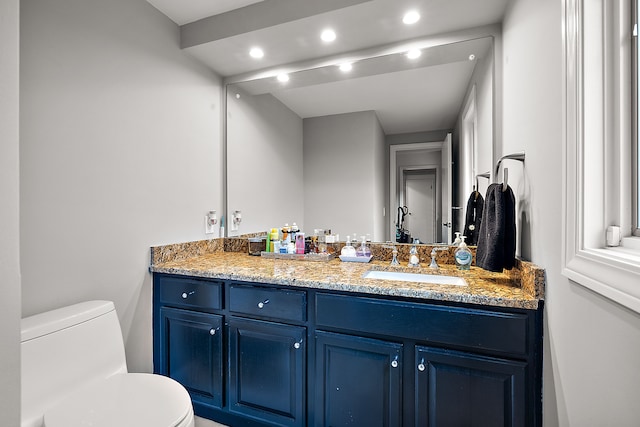 bathroom featuring recessed lighting, vanity, and toilet