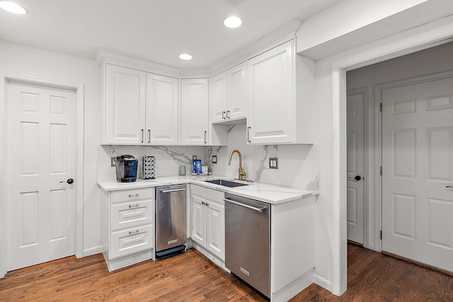 kitchen with dishwasher, white cabinetry, light countertops, and a sink