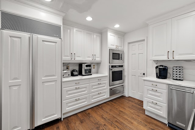 kitchen featuring dark wood-type flooring, built in appliances, white cabinetry, a warming drawer, and recessed lighting