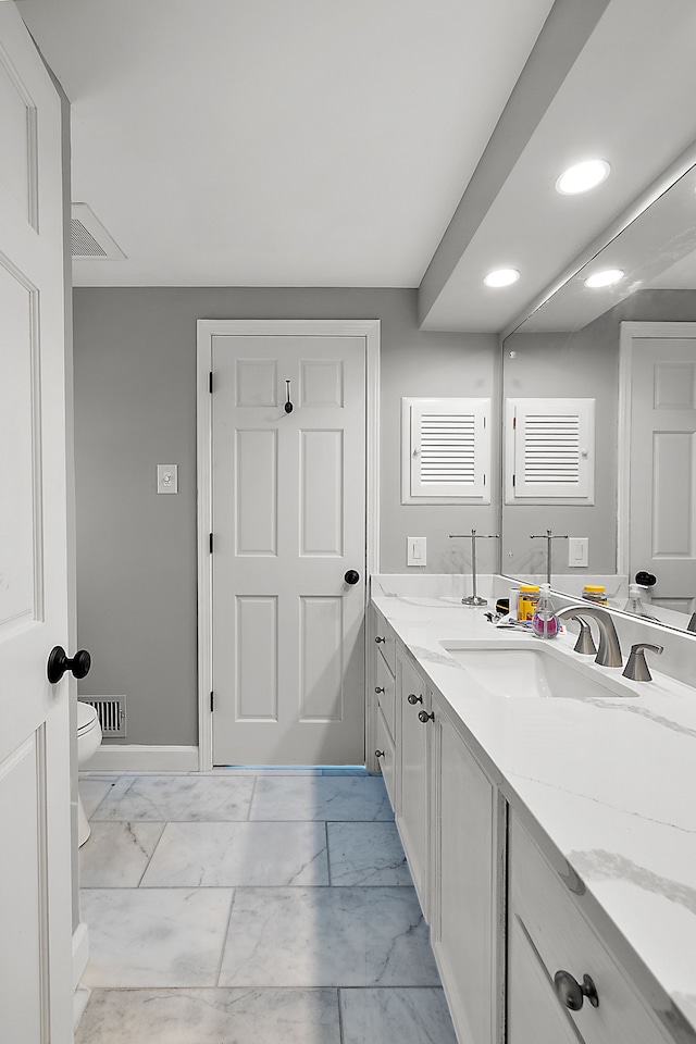 bathroom featuring marble finish floor, recessed lighting, visible vents, toilet, and vanity