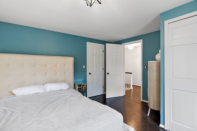 bedroom featuring dark wood finished floors and baseboards