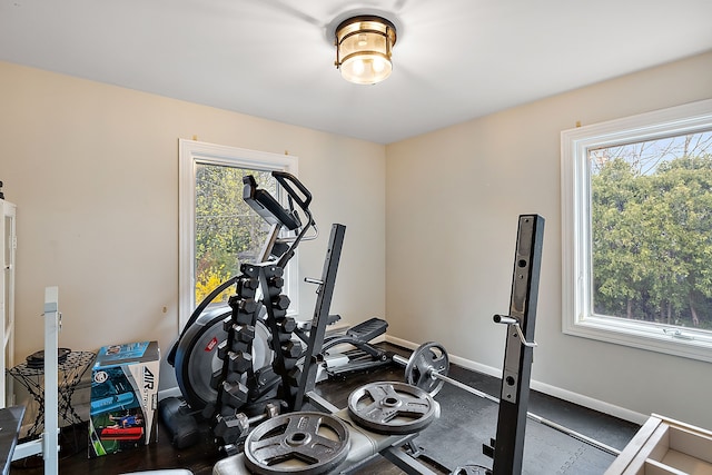 exercise room featuring baseboards and a wealth of natural light