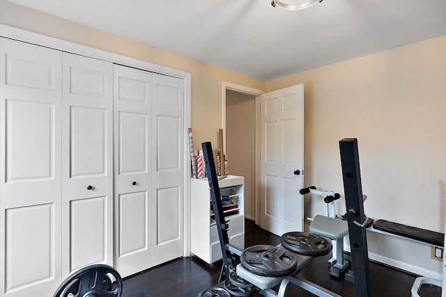 exercise room with dark wood-type flooring