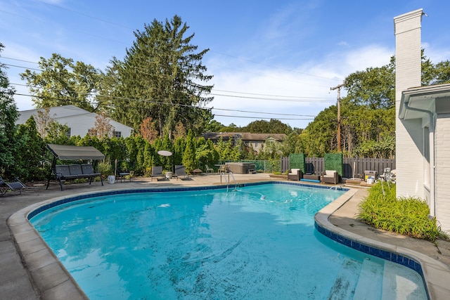 view of pool with a fenced in pool, a patio area, and fence