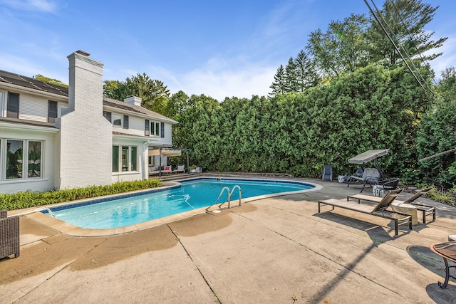 pool featuring a patio area