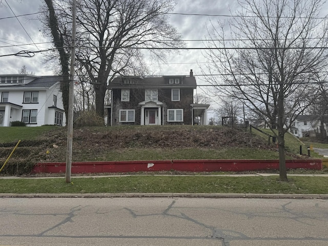 colonial house featuring brick siding