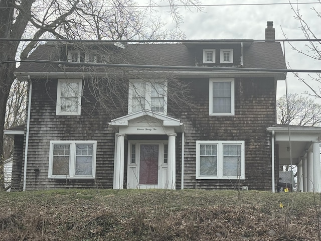 colonial-style house featuring a chimney
