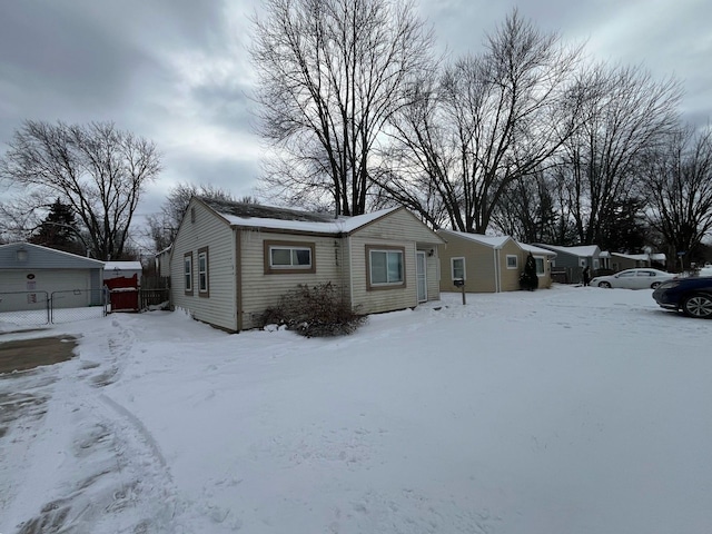 view of front of home with a garage and fence