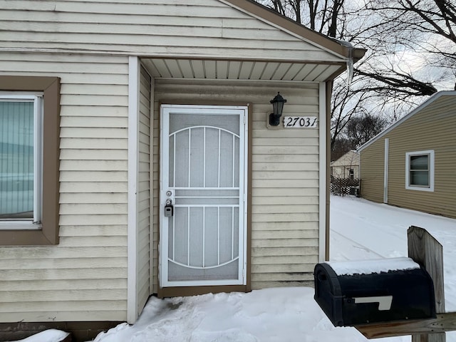 view of snow covered property entrance