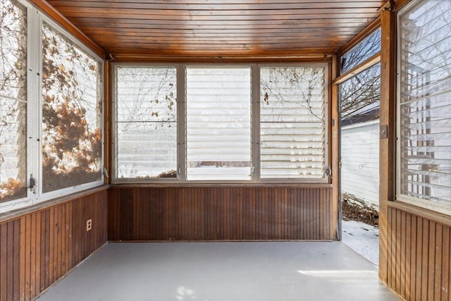 unfurnished sunroom with wood ceiling and a wealth of natural light