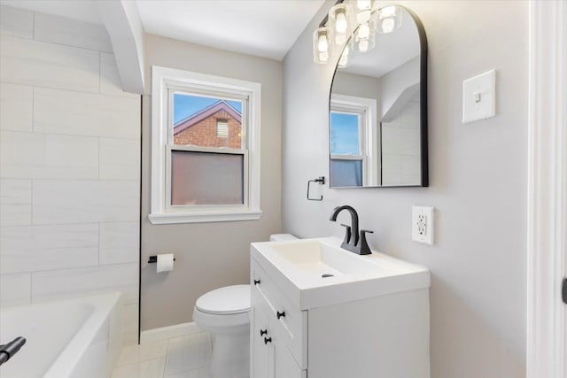 bathroom featuring toilet, vanity, and baseboards