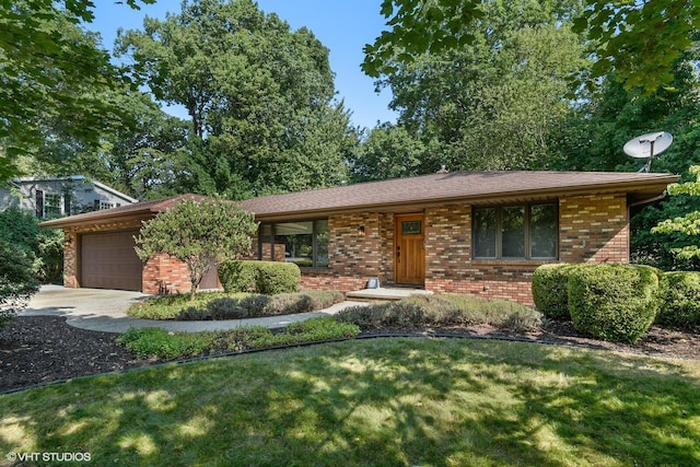 view of front of property featuring a garage, brick siding, driveway, and a front lawn