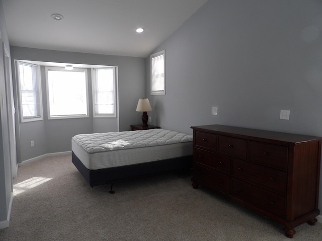 bedroom featuring lofted ceiling, light colored carpet, baseboards, and recessed lighting