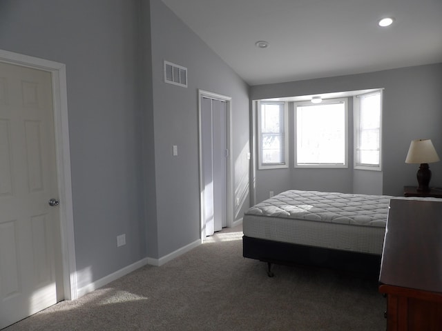 carpeted bedroom featuring recessed lighting, a closet, visible vents, vaulted ceiling, and baseboards