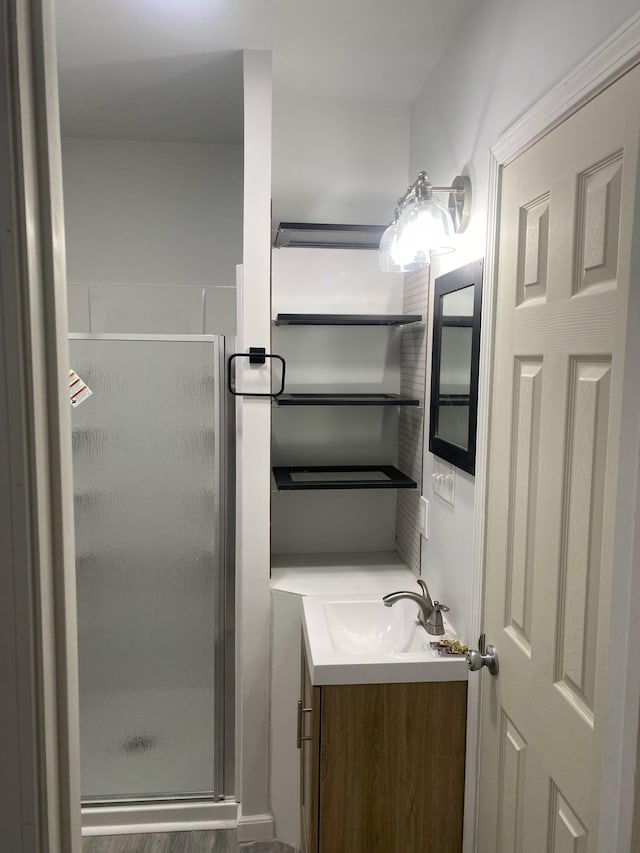 bathroom featuring a shower stall and vanity