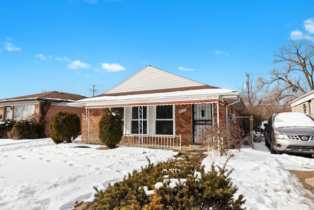 view of front of property with covered porch and brick siding