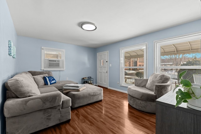 living room featuring dark wood-style flooring and baseboards