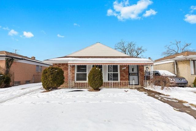 view of front of house with covered porch and brick siding