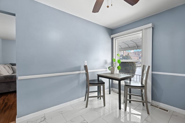 dining space with marble finish floor, a ceiling fan, visible vents, and baseboards