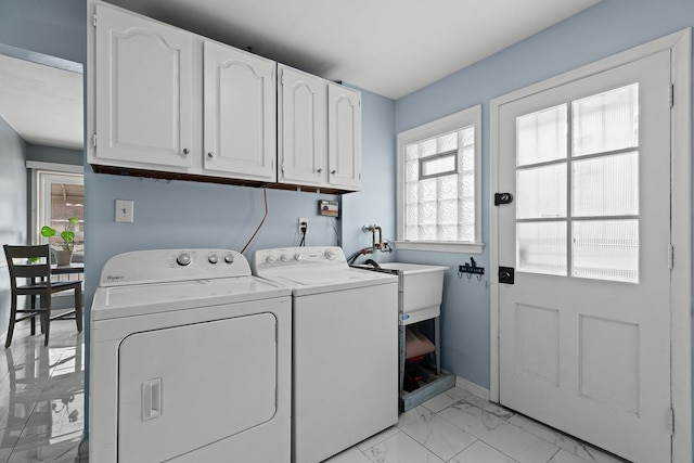 washroom featuring cabinet space, marble finish floor, and washing machine and clothes dryer