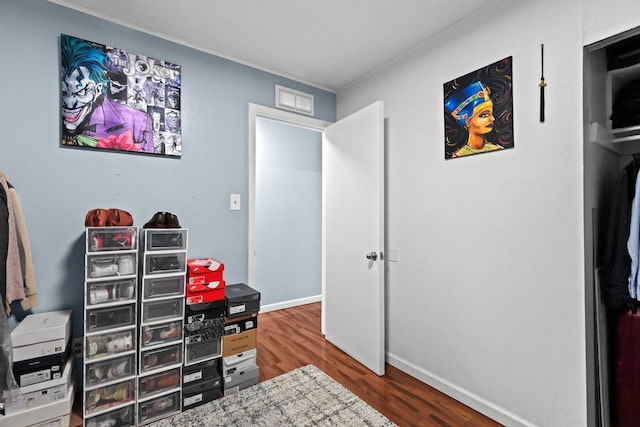 interior space with visible vents, baseboards, and wood finished floors