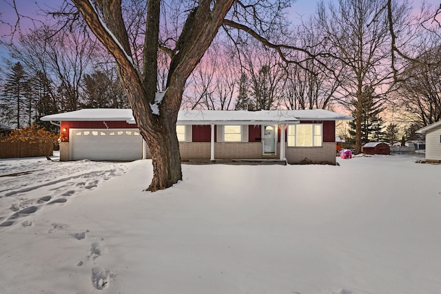 ranch-style house featuring brick siding and an attached garage