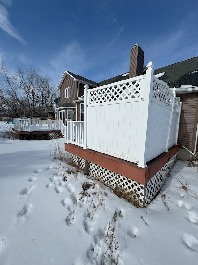 view of snow covered exterior featuring a deck