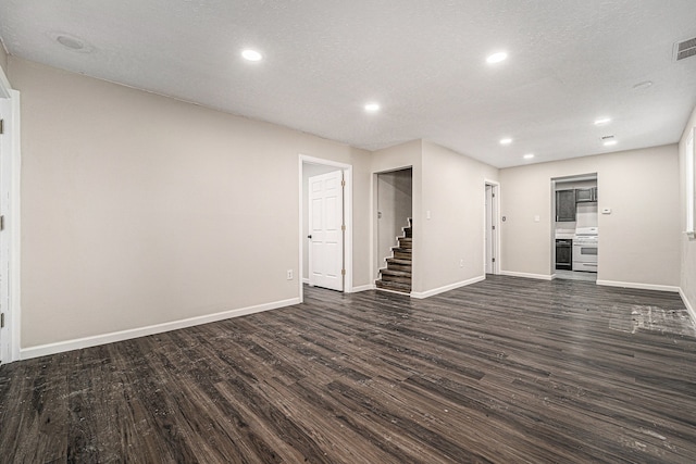 spare room with visible vents, baseboards, dark wood finished floors, and recessed lighting