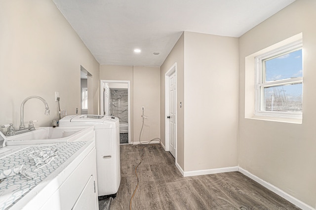 laundry room featuring laundry area, washer / clothes dryer, a sink, and baseboards