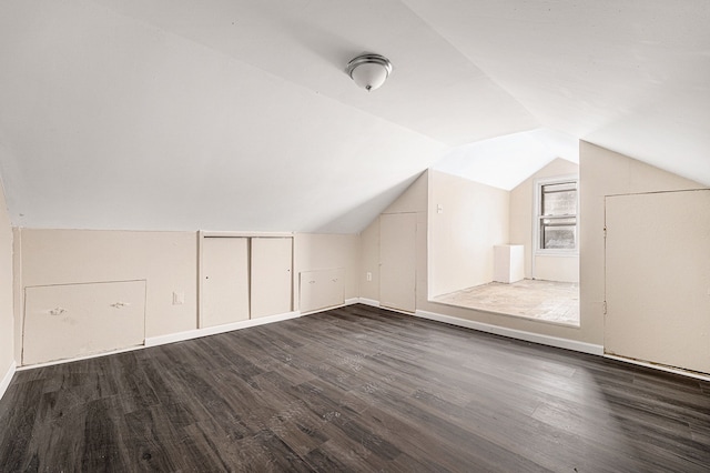 additional living space with lofted ceiling and dark wood finished floors