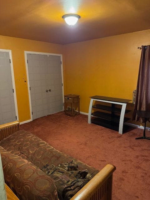 carpeted bedroom featuring baseboards