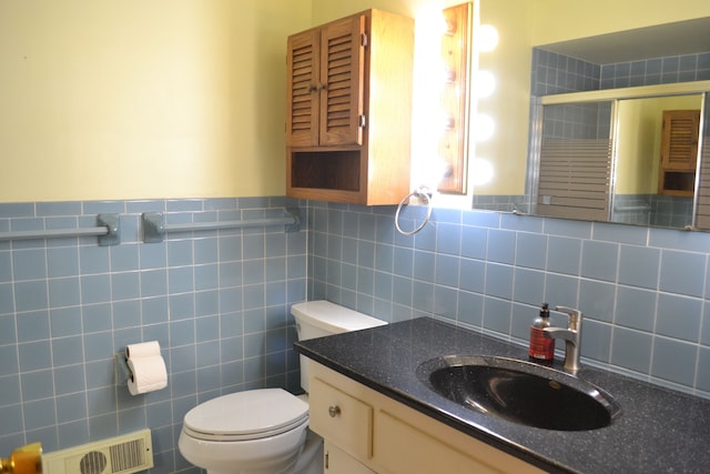 bathroom with visible vents, a shower stall, toilet, and vanity