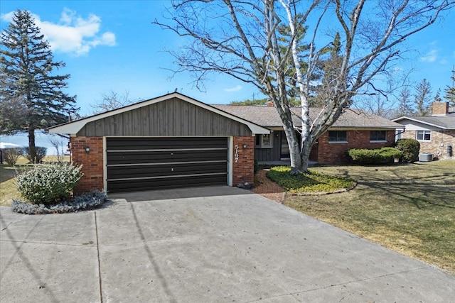 single story home with brick siding, a front lawn, central air condition unit, concrete driveway, and an attached garage